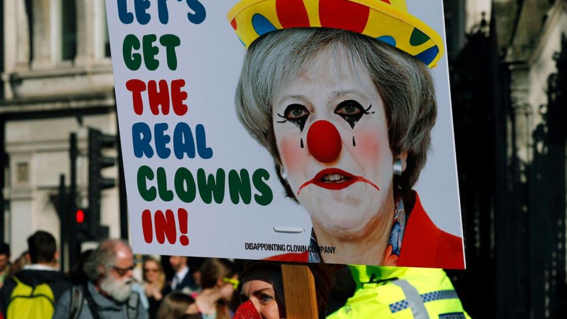A Demonstrator protests at the entrance of the Houses of Parliament in London, Tuesday, Feb. 26, 2019.