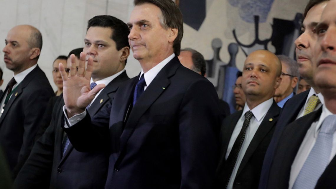 Brazil's President Jair Bolsonaro, centre, arrives at the National Congress to deliver a proposal to overhaul Brazil's pension system, in Brasilia. 