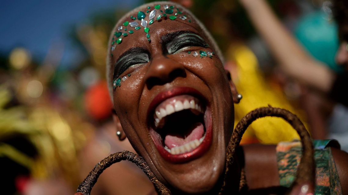 A reveler in costume laughs during the "Cordao do Boitata" street party in Rio de Janeiro, Brazil, Sunday, Feb. 24, 2019