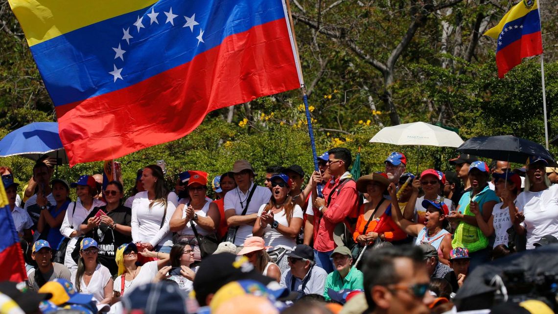 Anti-government protesters start to gather for a rally to demand the resignation of Venezuelan President Nicolas Maduro in Caracas, Venezuela, Monday, March 4, 2019.