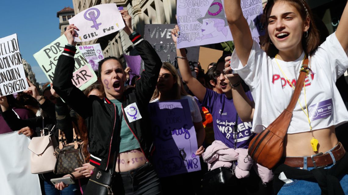 Student protesters shout slogans during a demonstration marking International Women's Day in Barcelona on March 8, 2019. Unions, feminist associations and left-wing parties have called for a work stoppage for two hours on March 8, hoping to recreate the strike and mass protests seen nationwide to mark the same day in 2018. 