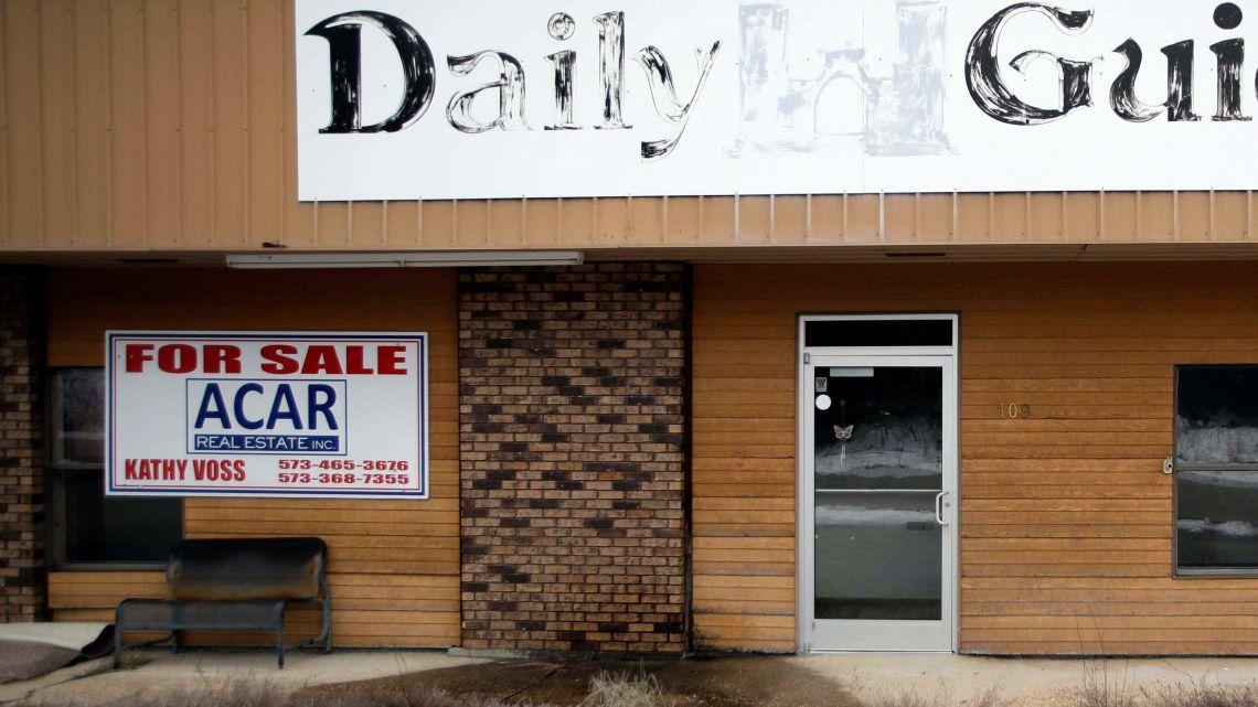 A "For Sale" sign posted on the old office of the Daily Guide, a newspaper that folded in Missouri. 1,400 other cities across the United States have lost a newspaper over the past 15 years.