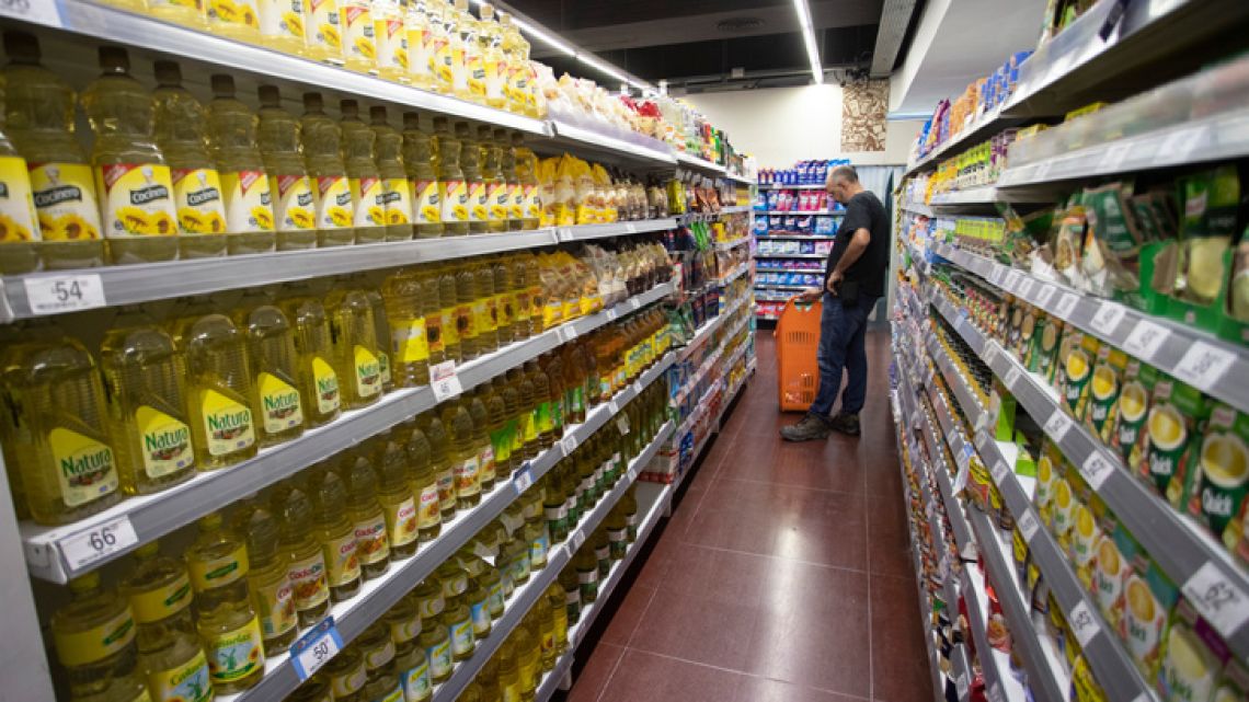 A shopper checks prices in a Carrefour supermarket in the capital.