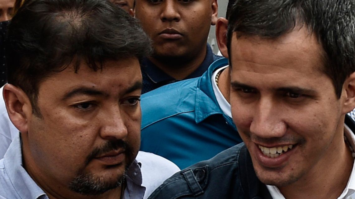 In this file photo taken on March 08, 2019 Venezuelan opposition leader Juan Guaidó (right) stands next to his Chief-of-Staff Roberto Marrero, during a rally on International Women's Day in Caracas.