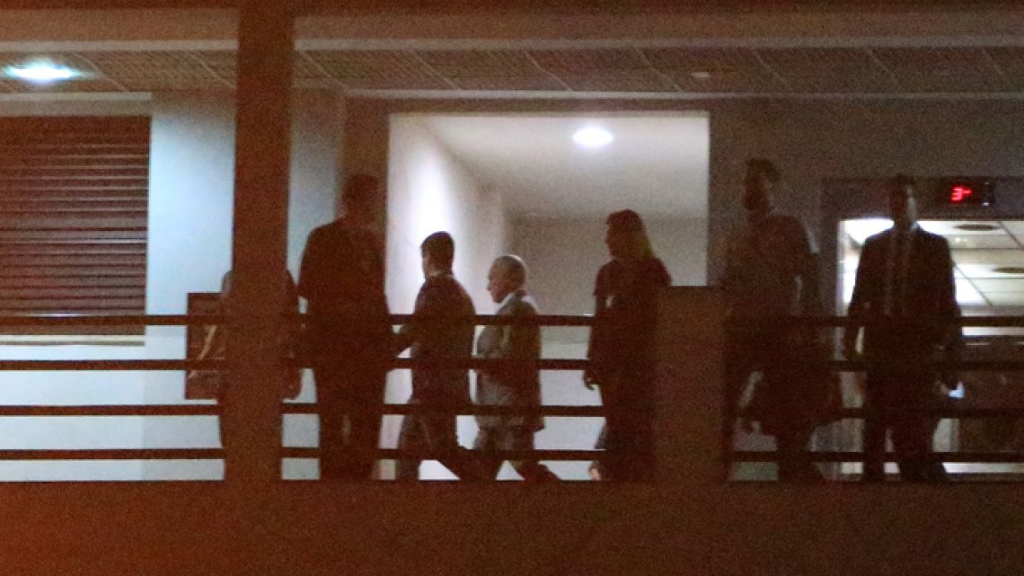 Former Brazilian president Michel Temer, centre, arrives to the Federal Police headquarters in Rio de Janeiro, Brazil, late Thursday, March 21, 2019.