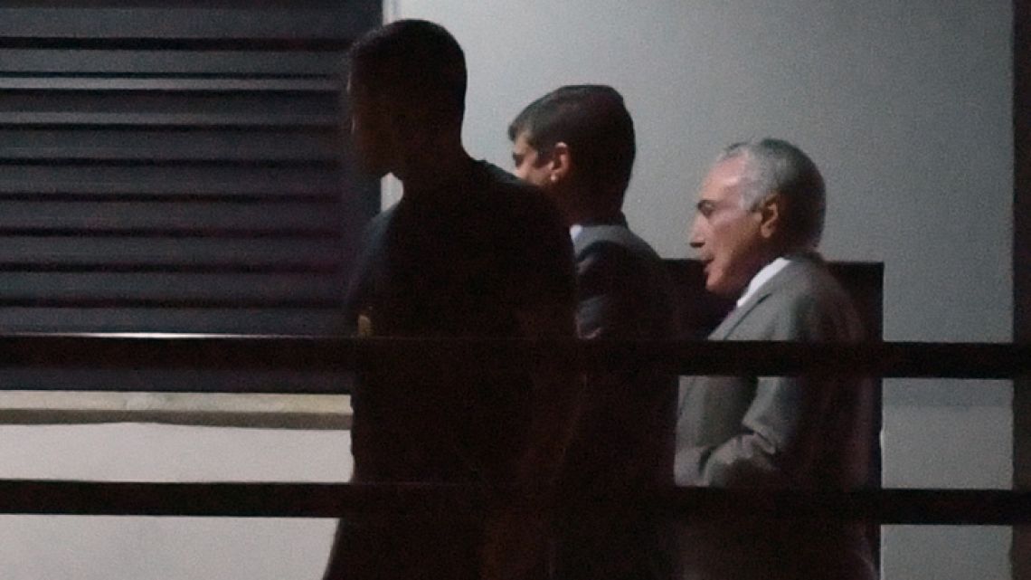 Brazil's former president Michel Temer, arrives under police escort at the Federal Police headquarters in Rio de Janeiro, Brazil, on March 21.
