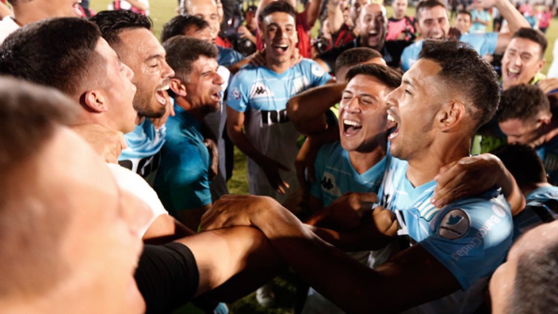 Racing Club players and staff celebrate clinching the Superliga Championship title, after a match against Tigre on the outskirts of Buenos Aires.