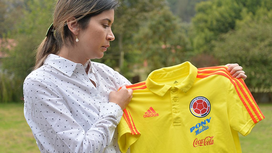 Physiotherapist Carolina Rozo, former physio of the Colombian under-17 national football team, shows a jersey of the team during an interview to AFP in Bogota, on April 3, 2019. Accusations of sexual abuse and harassment in Colombian women's football have started to be unveiled, followed by a handful of allegations by referees that enlarged the scandal. Rozo has claimed that for having rejected the team's former coach advances in December 2017 she suffered professional retaliation that caused her depression. 