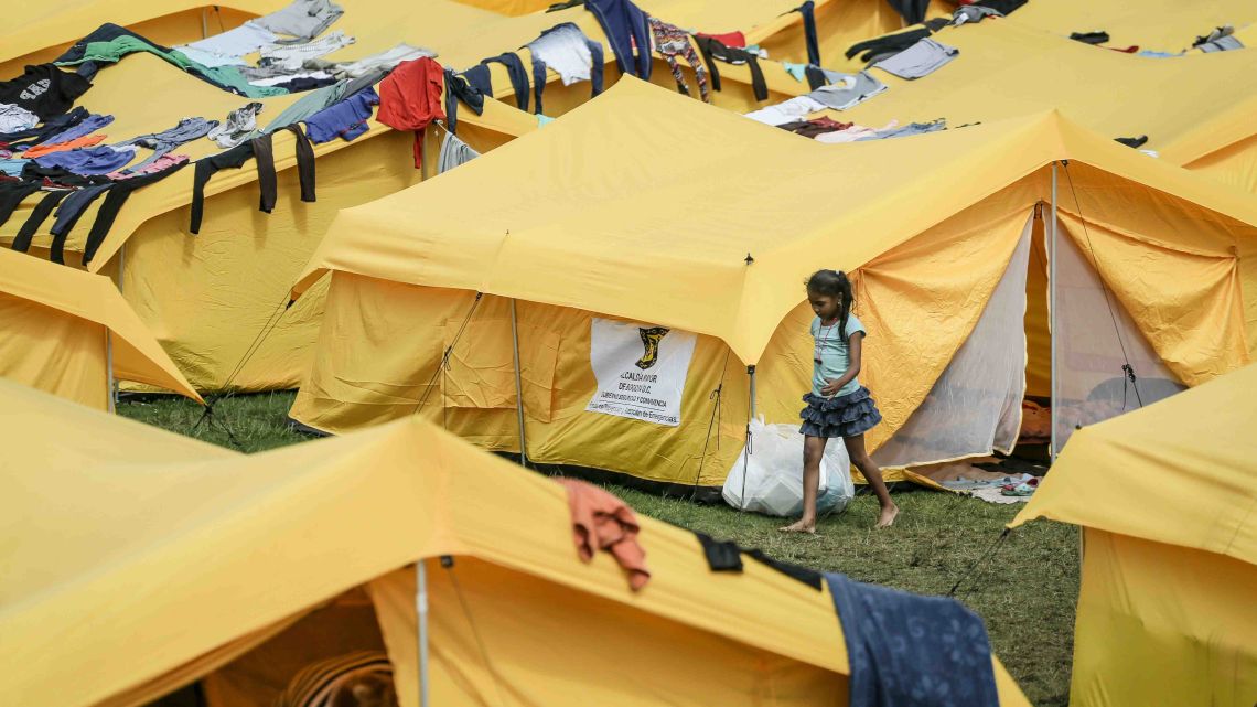 A girl walks in a camp built by the municipal government for homeless Venezuelan migrants in Bogota, Colombia.