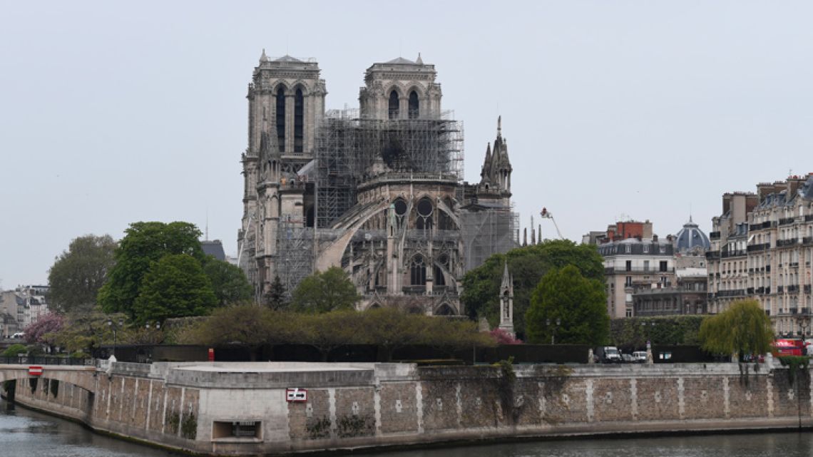 A picture shows Notre-Dame Cathedral in Paris on April 16, 2019, in the aftermath of a fire that caused its spire to crash to the ground. Crowds of stunned Parisians and tourists -- some crying, others offering prayers -- watched in horror in central Paris on April 15 night as firefighters struggled for hours to extinguish the flames engulfing the Notre-Dame Cathedral. 