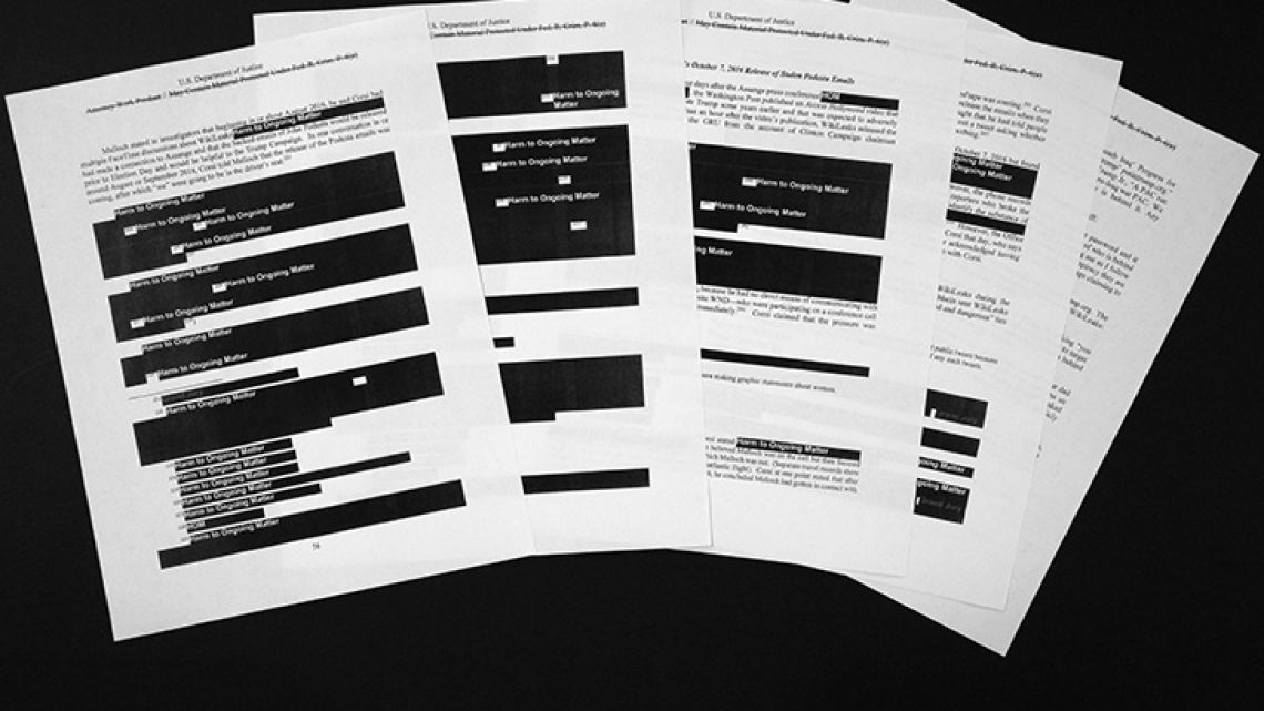 US Special counsel Robert Mueller's redacted report on the investigation into Russian interference in the 2016 presidential election is photographed Thursday, April 18, 2019, in Washington. The pages deal with Julian Assange and WikiLeaks.