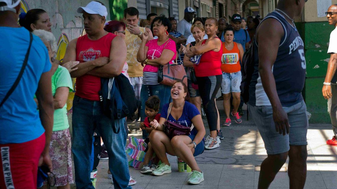 People wait in line to buy chicken at a government-run grocery store in Havana, Cuba, Wednesday, April 17, 2019. Hours-long lines appear within minutes when trucks show up with new supplies, and shelves are empty again within hours.