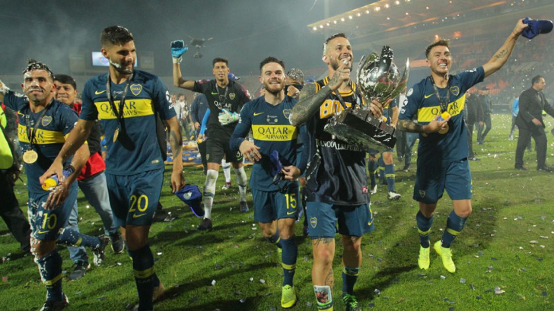 Boca Juniors players celebrating after clinching the Supercopa Argentina title.