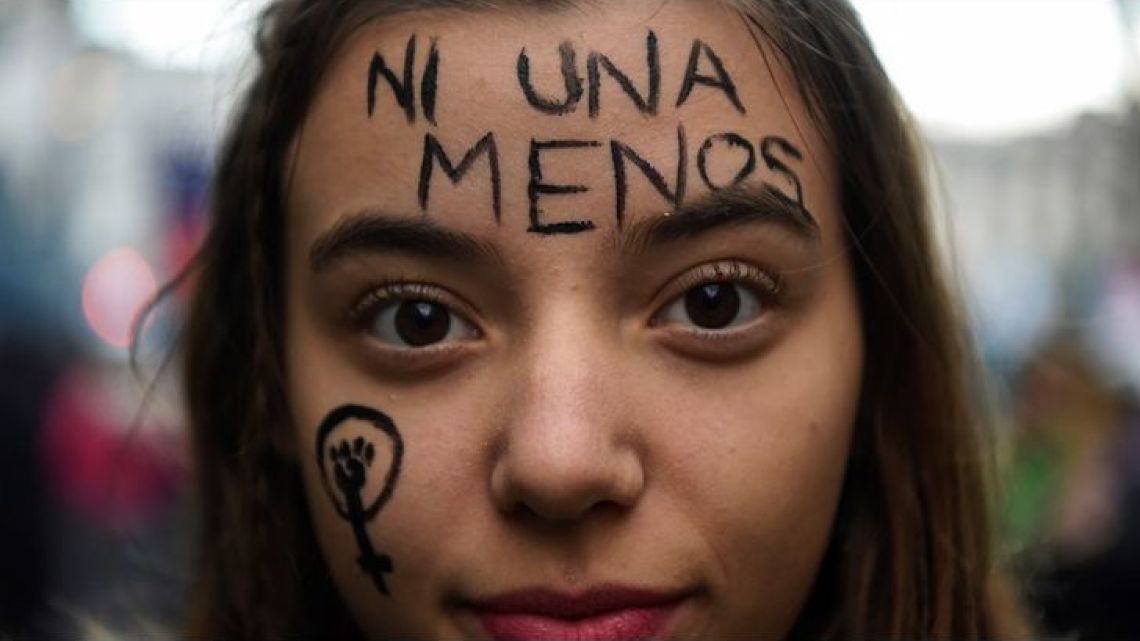 'Ni Una Menos,' a slogan meant to denounce the prevalence of femicide, written across a young women's forehead.