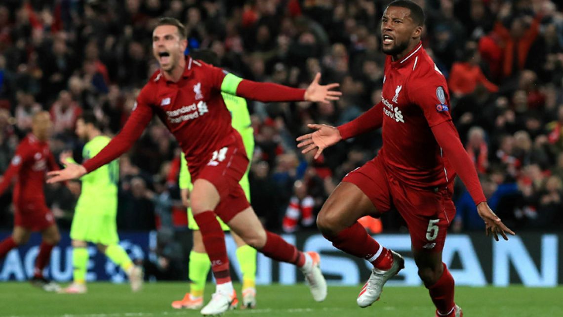 Liverpool's Georginio Wijnaldum, right, celebrates scoring his side's third goal of the game during the Champions League Semi Final, second leg soccer match between Liverpool and Barcelona at Anfield, Liverpool, England, Tuesday, May 7, 2019.