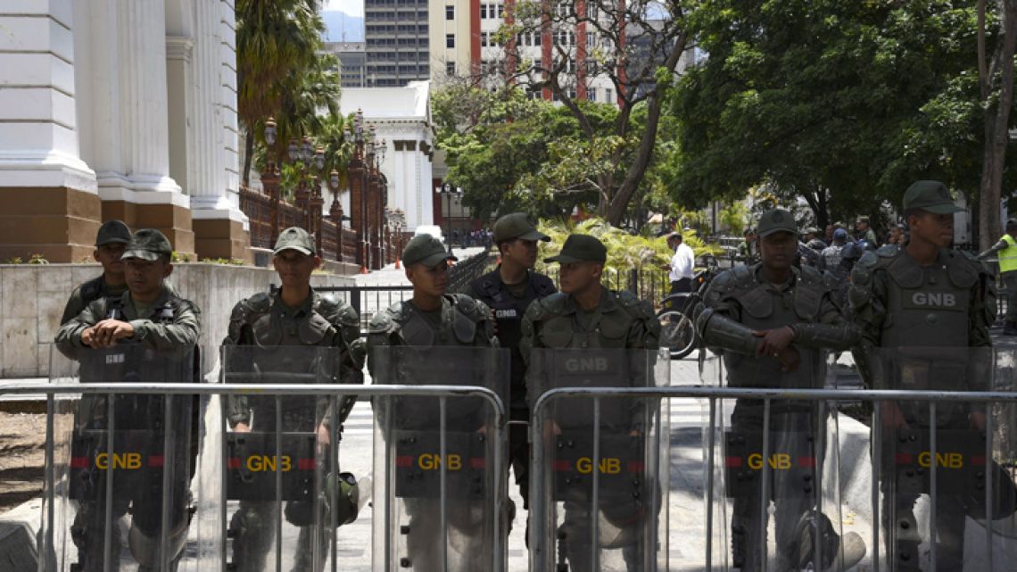 Members of the Bolivarian National Guard stand guard outside the building of the National Assembly, where a plenary session is taking place with the presency of Venezuelan opposition leader and self-declared president Juan Guaidó in Caracas, on May 7, 2019. Venezuela's Constituent Assembly, which rules the South American country with absolute powers, plans to strip parliamentary immunity from opposition lawmakers who backed a failed uprising this week, leader Diosdado Cabello said Sunday. 