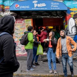 Tourists are seen in front of street murals in Valparaíso, Chile, on April 22, 2019.