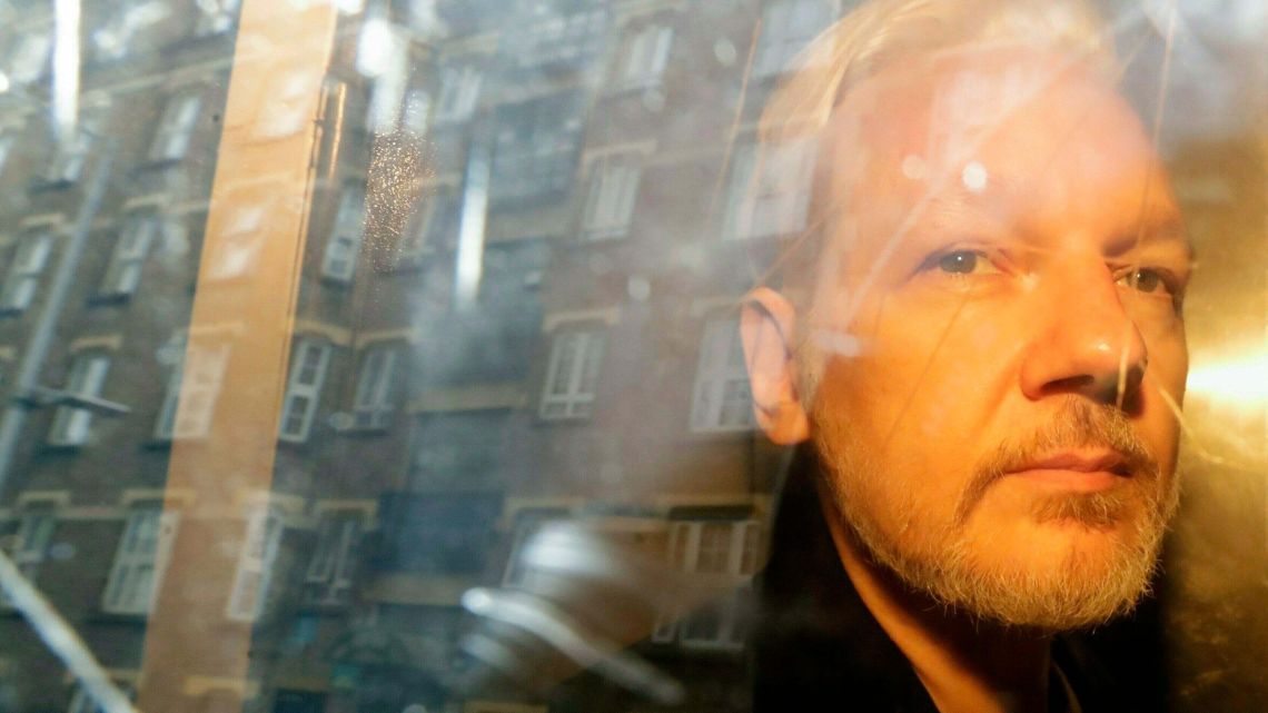 Buildings are reflected in the window as WikiLeaks founder Julian Assange is taken from court, where he appeared on charges of jumping British bail seven years ago, in London. Swedish prosecutors plan to decide whether they will reopen a rape case against WikiLeaks founder Julian Assange.