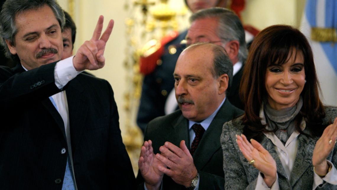 Photo taken on July 24, 2008, shows then-outgoing Cabinet chief Alberto Fernández (left), flashing the "V" sign next to then-president Cristina Fernández de Kirchner. 