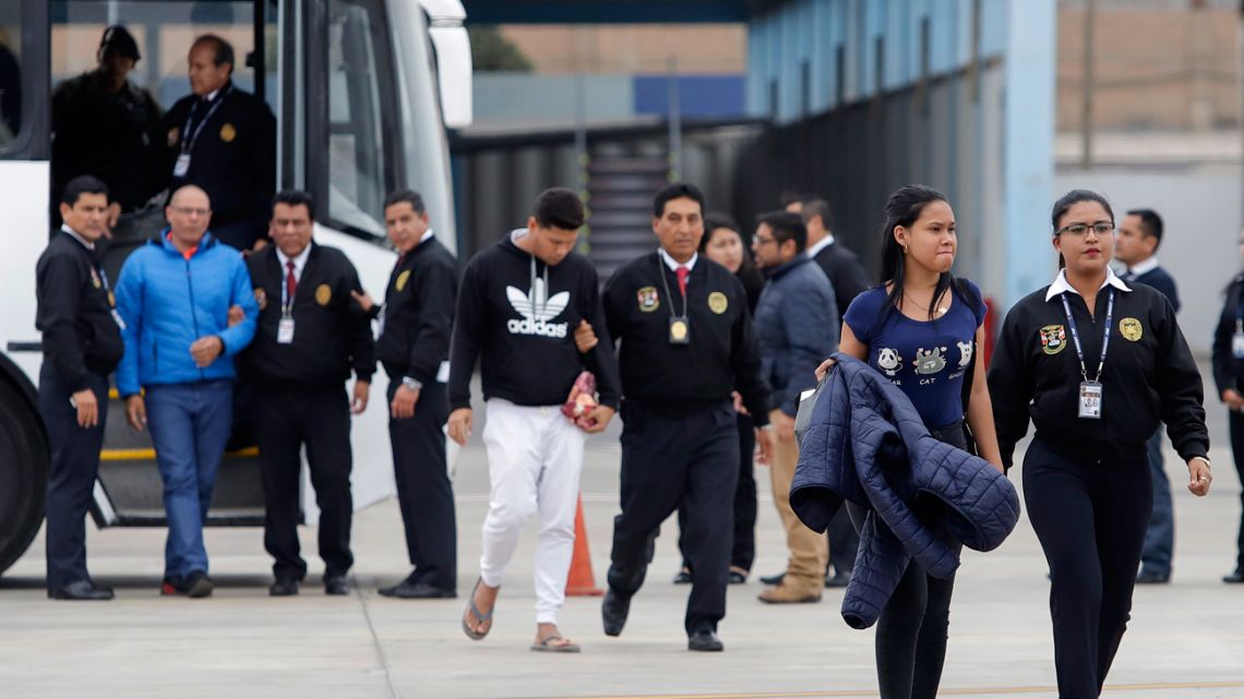 This handout picture released by Peruvian Interior Ministry shows Venezuelan nationals being deported from Peru at a military airport in Callao.
