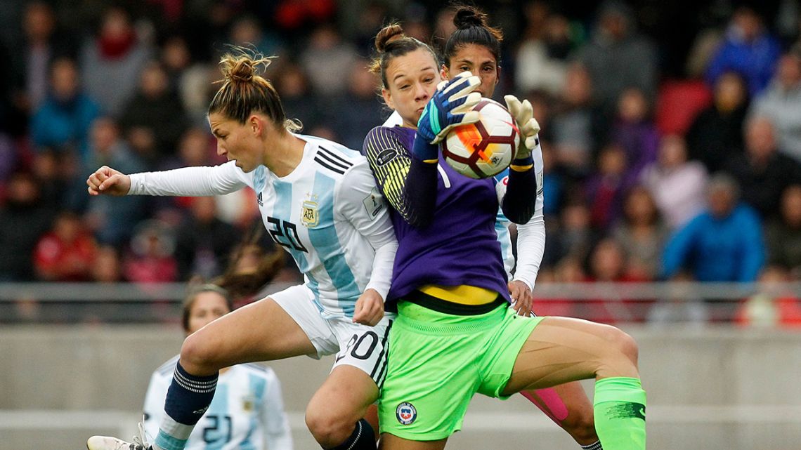 This file photo taken on April 22, 2018 shows Argentina's Aldana Cometti (left) challenging Chile's goalkeeper Christiane Endler (right) for the ball during the Women's Copa América match at La Portada stadium in Serena.