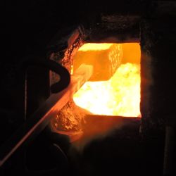El trabajo comienza encendiendo la fragua para que llegue hasta los 1.250 °C.