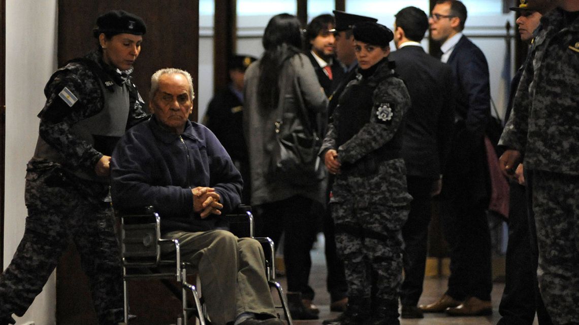 Italian Catholic priest Nicola Corradi (L, on wheelchair) is escorted as he leaves a courtroom after the beginning of his trial over allegations of sexual abuse in Mendoza, Argentina, on August 5, 2019.