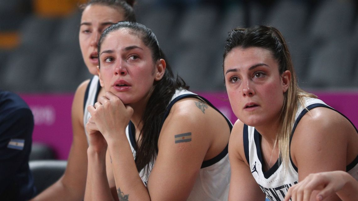 Argentina's players watch the women's basketball match against the Virgin Islands from the bench, at the Pan American Games in Lima, Peru, Thursday, August 8, 2019. Argentina's women's basketball team had to forfeit its match against Colombia at the Pan American Games on Wednesday for wearing the wrong uniform color. Argentina won today’s match against the Virgin Islands but is out of the medal rounds because of the uniform blunder. 