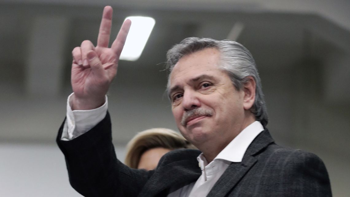 Presidential hopeful for the Frente de Todos party Alberto Fernández flashes the V sign before voting during primary elections in Buenos Aires on August 11.