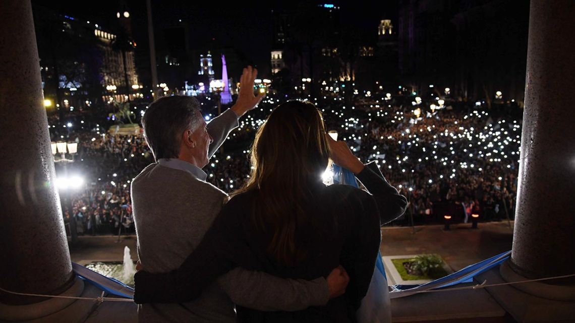 President Mauricio Macri and his wife, Juliana Awada, wave from the balcony of the Casa Rosada to supporters.
