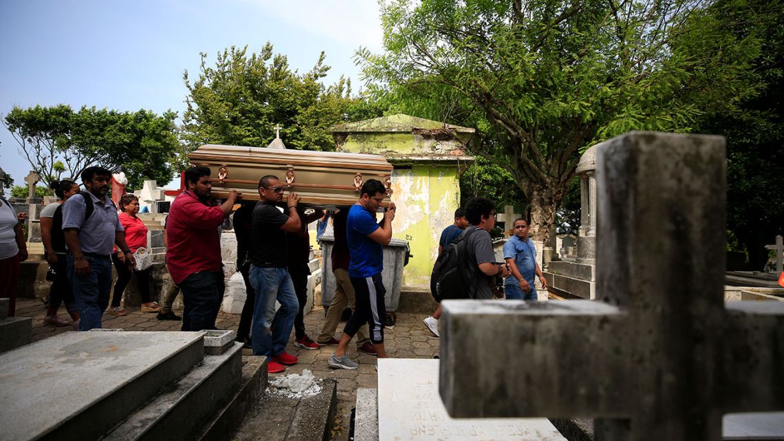 Mourners carry the coffin that contain the remains of Erick Hernandez Enriquez, also known as DJ Bengala, who was killed in an attack on the White Horse nightclub where he was DJ'ing, as they bring him for burial at the municipal cemetery in Coatzacoalcos, Veracruz state, Mexico, Thursday, Aug. 29, 2019.