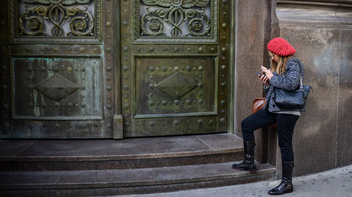 A woman waits outside a bank in Buenos Aires on September 2, 2019. 