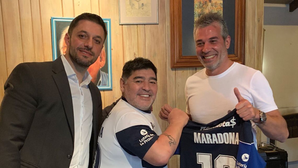 Diego Maradona (centre), pictured with his lawyer Matías Morla (left) and Gimnasia y Esgrima La Plata President Gabriel Pellegrino.