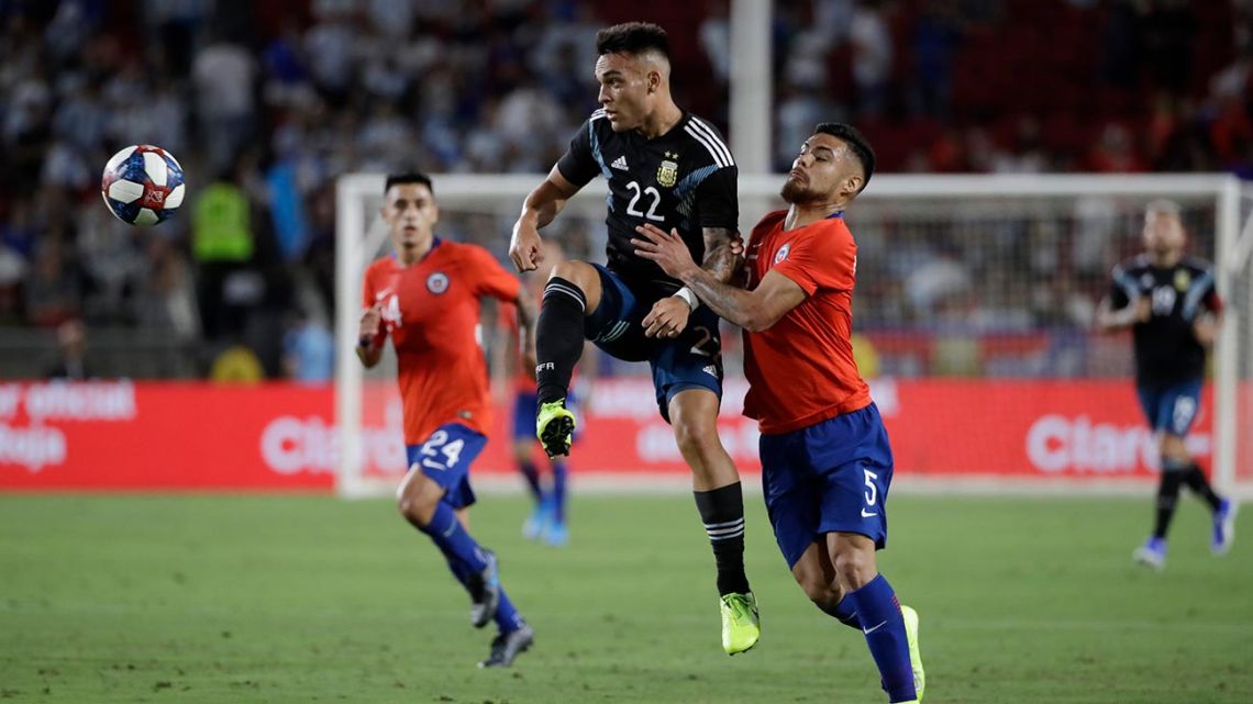 Lautaro Martínez and Chile's Paulo Díaz challenge for a ball in the international friendly football match between Chile and Argentina, on Thursday, September 5, 2019, in Los Angeles.