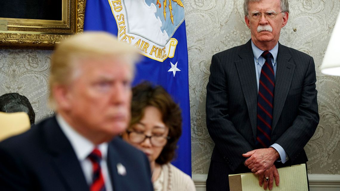 U.S. President Donald Trump, left, meets with South Korean President Moon Jae-In in the Oval Office of the White House in Washington, as national security adviser John Bolton, right, watches, in May 2018.