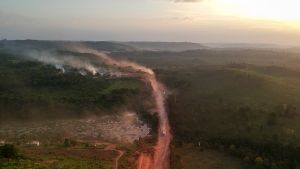 In this aerial view the red dust of the BR230 highway, known as 'Transamazonica,' mixes with fires at sunset in the agriculture town of Ruropolis, Para state, northen Brazil, on September 6, 2019.