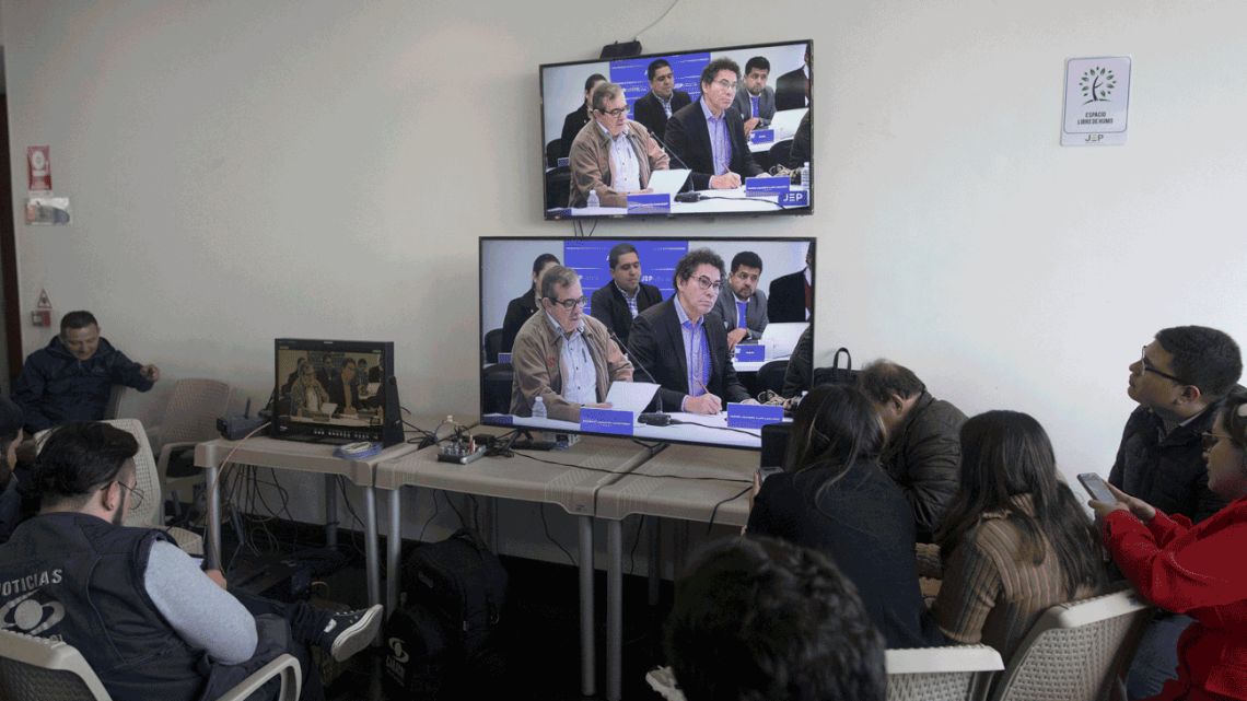 ournalists watch former rebel leaders' appearance before Colombia's special peace tribunal to testify in an ongoing probe of their role in civilian kidnappings in Bogota, Colombia.