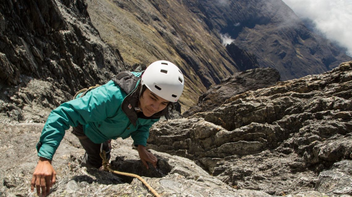Scientist Cherry Andrea Rojas scales rocks during an expedition to the Humbolt glacier, in Merida, Venezuela