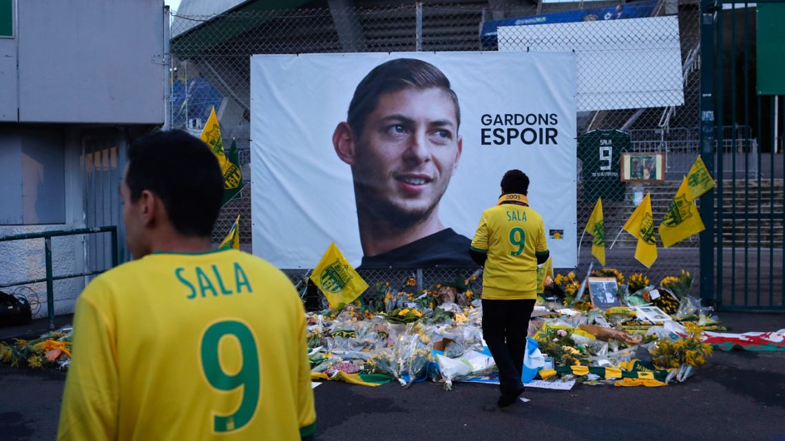 In this January 2019 file photo, Nantes supporters stand by a poster of Argentine player Emiliano Sala outside the La Beaujoire stadium in Nantes.