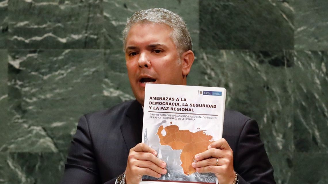Colombia's President Ivan Duque holds a book as he addresses the 74th session of the United Nations General Assembly.