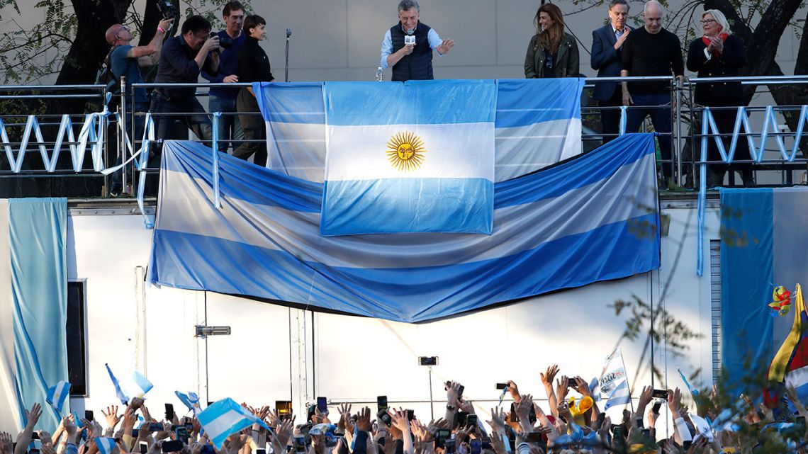 President Mauricio Macri waves to followers during his '#SiSePuede' rally in Barrancas de Belgrano on Saturday. Macri is attempting to resurrect his re-election campaign with '30 marches in 30 cities' ahead of October's vote.