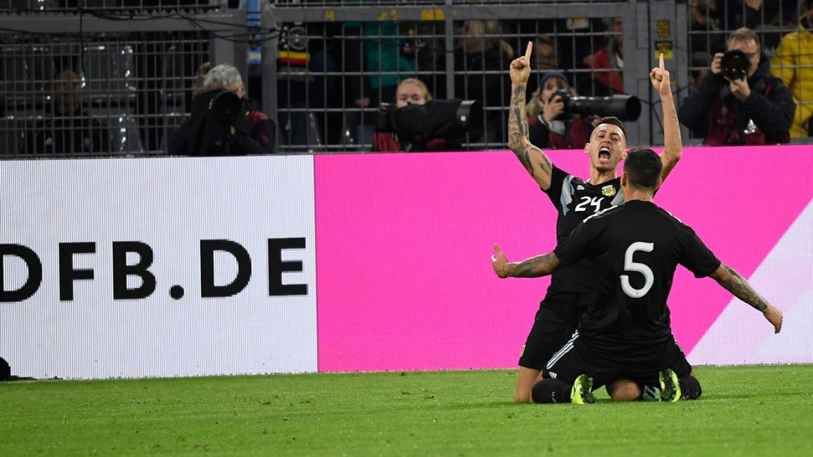 Argentina midfielders Lucas Ocampos (left) and Leandro Paredes celebrate during the 2-2 friendly football match against Germany at Signal-Iduna Park in Dortmund.