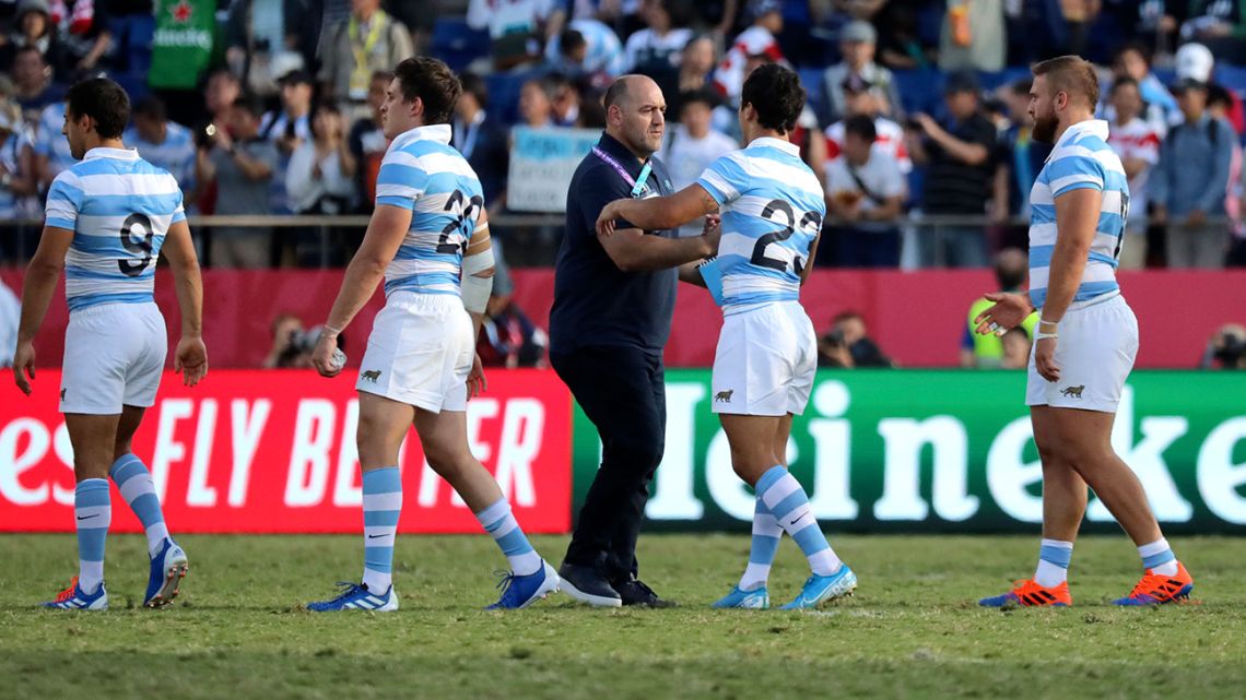 Argentina coach Mario Ledesma shakes hands with his players, as they leave the field following their Rugby World Cup Pool C game against the United States in Kumagaya City, Japan, Wednesday, October 9, 2019.