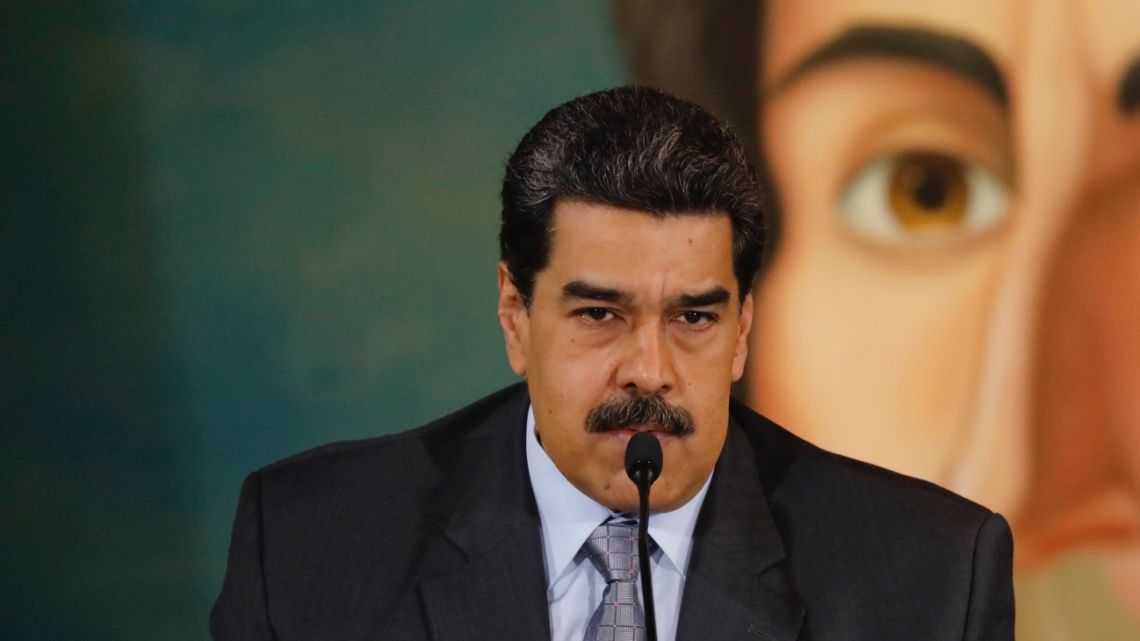 Backdropped by a painting of independence leader Simon Bolivar, Venezuela's President Nicolas Maduro gives a press conference at the Foreign Ministry in Caracas, Venezuela.