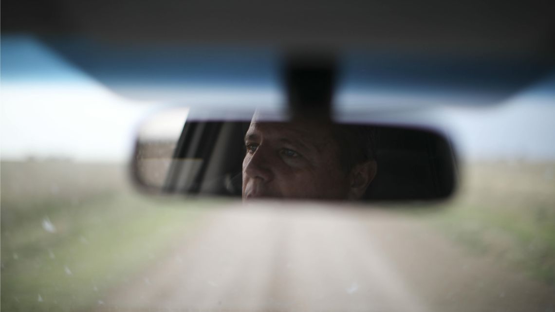 Farmer Juan Rossi is reflected in his rearview mirror on the outskirts of Pergamino, Argentina in this October 9, 2019 photo. 