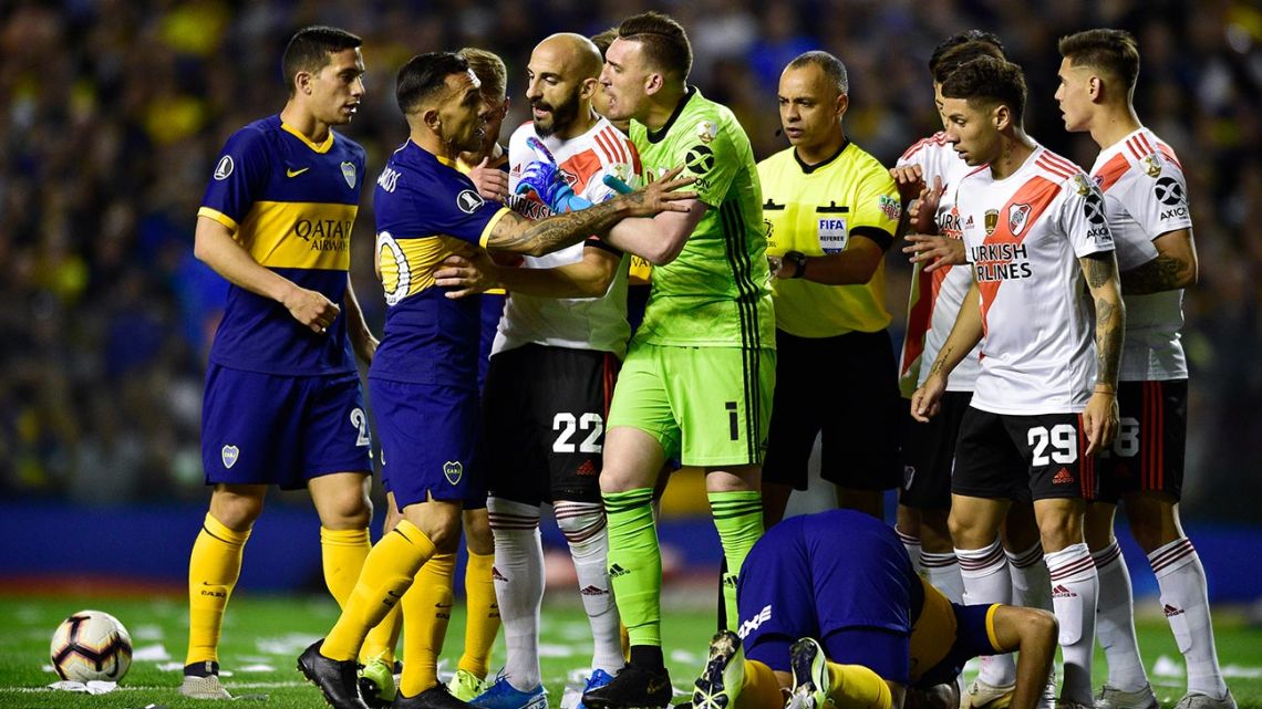 Goalkeeper Franco Armani of River Plate and Carlos Tevez of Boca Juniors argue as their teammates surround them, during a Copa Libertadores semi-final second leg at La Bombonera.