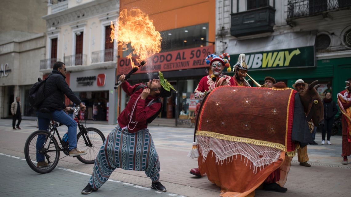 A member of the Brazilian theater group Clowns of Shakespeare spits fire during a performance in Bogota, Colombia.