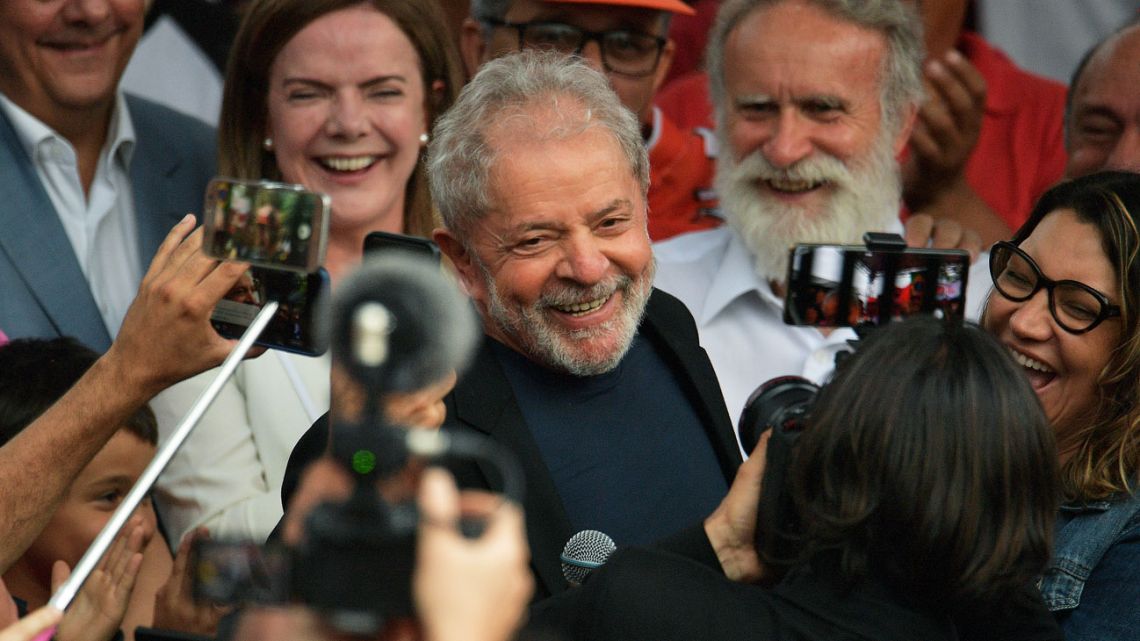 Brazil’s former president Luiz Inácio Lula da Silva, centre, smiles as he exits the the Federal Police headquarters where he was imprisoned on corruption charges in Curitiba.