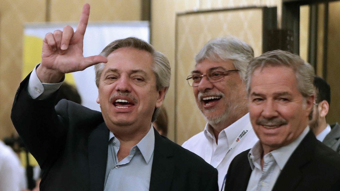 Argentina's President-elect Alberto Fernández flashes the "Lula Free" sign next to former Paraguayan president Fernando Lugo (C) and Argentine deputy Felipe Solá, before the opening of the second meeting of Puebla Group in Buenos Aires, on November 9, 2019. 