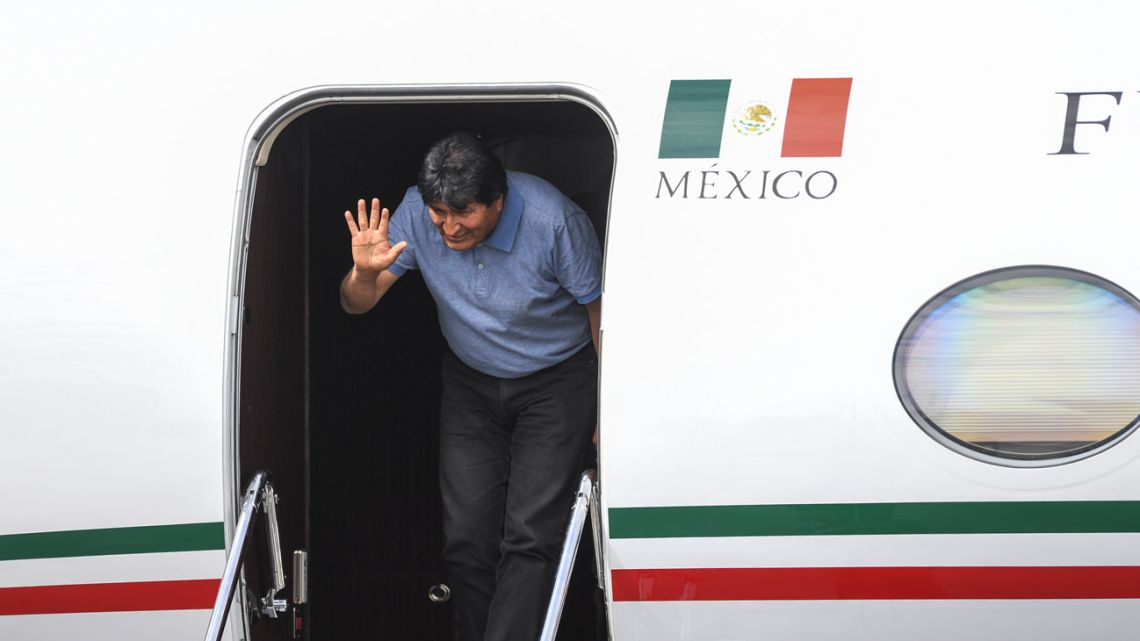 Bolivian former president Evo Morales waves upon landing in Mexico City, on November 12, 2019, where he was granted exile after his resignation.